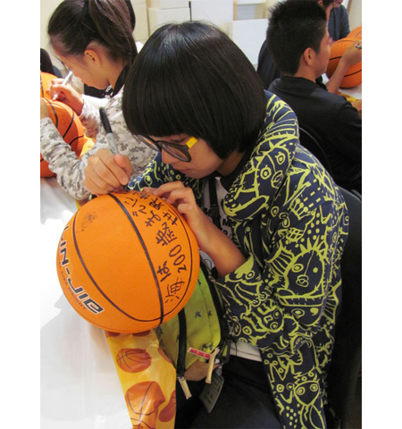 Pyramid project 3, participants decorating basketballs for the pyramid
